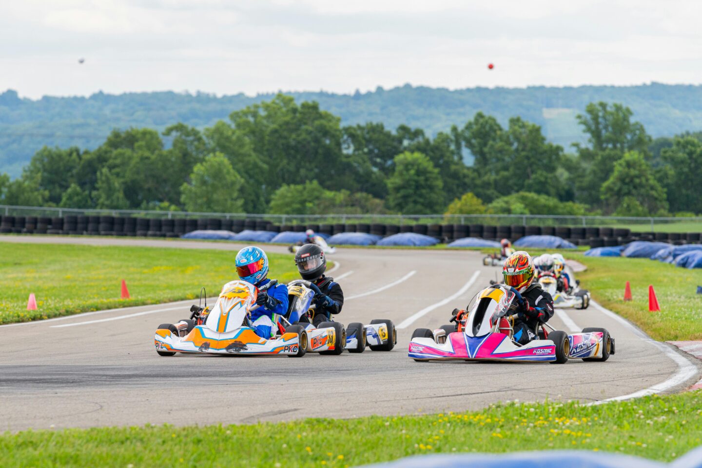 Teen boys go-karting on a track—adventurous and exciting gift experience for teenagers.