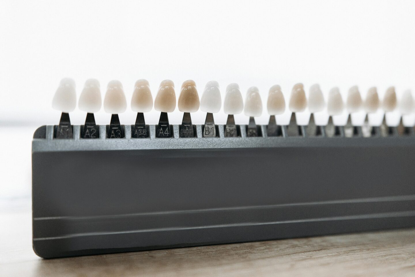 A dental shade guide featuring various shades of teeth.