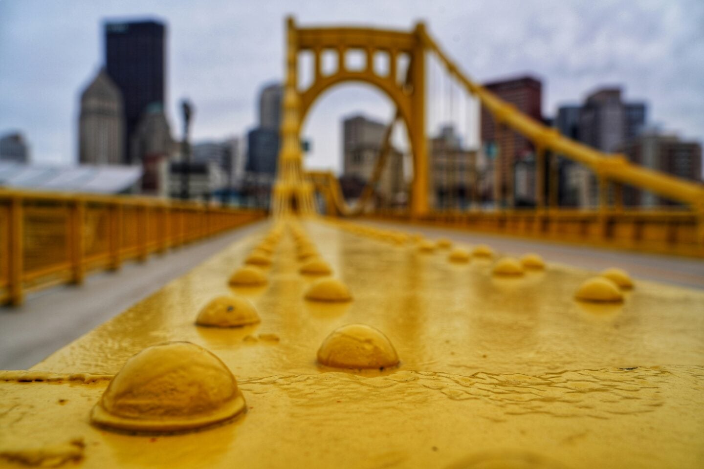 Close-up of yellow Pittsburgh bridgecovered in rain drops