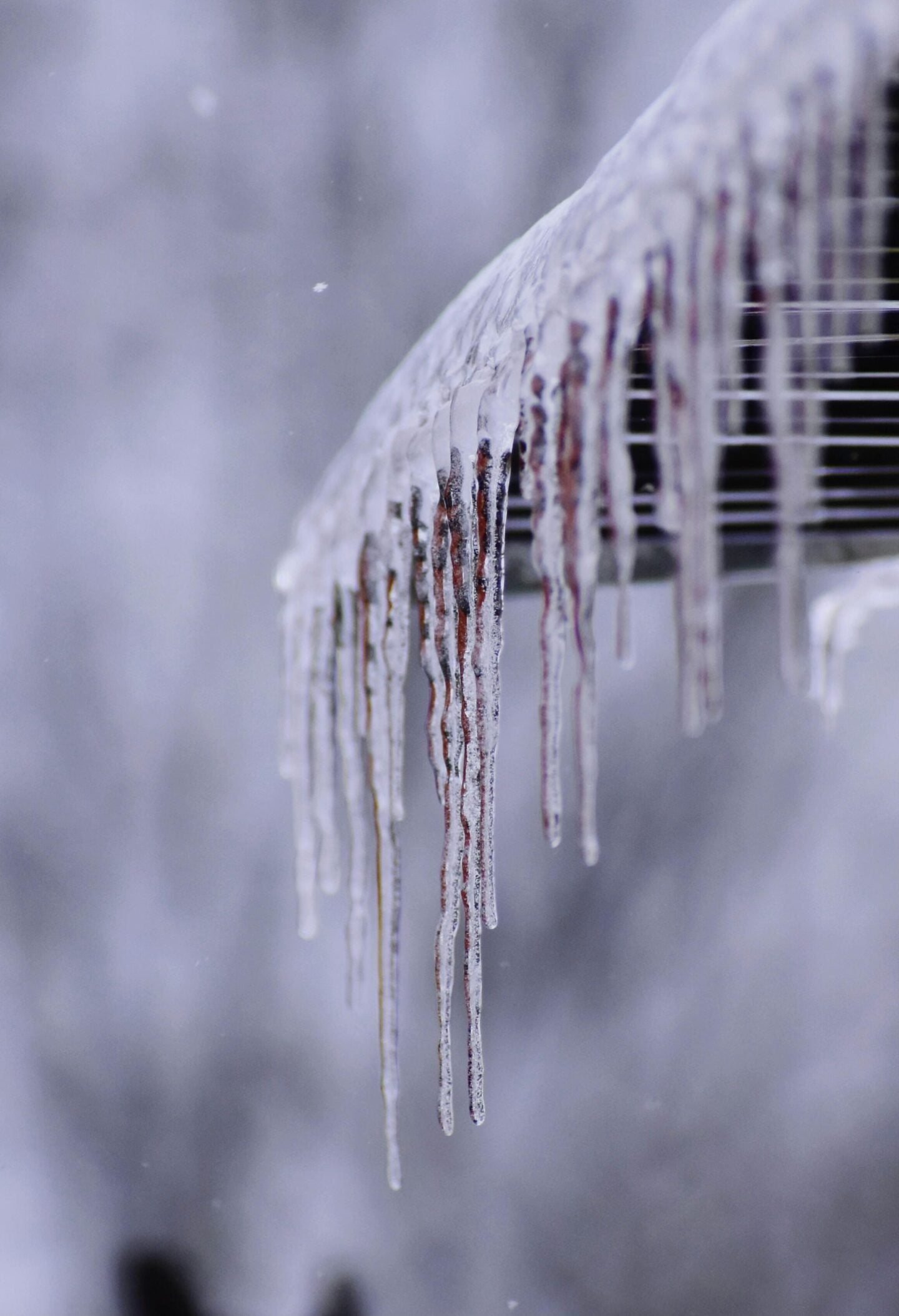 Icicles forming on a roof edge in Pittsburgh during winter ice dams