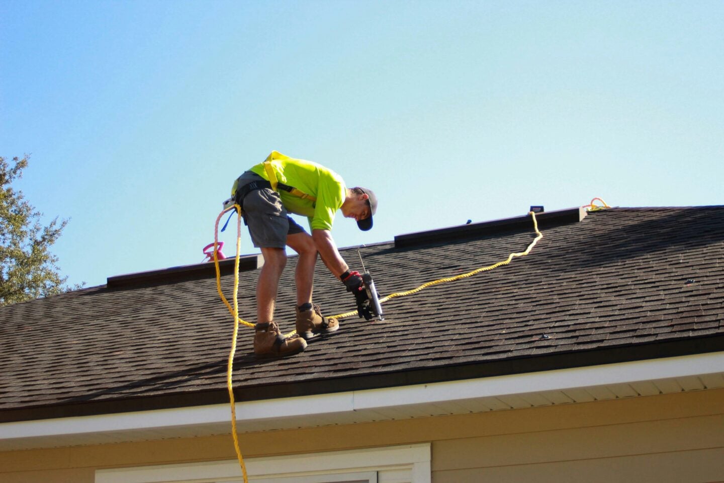 Roofer repairing shingles on a Pittsburgh home roof 