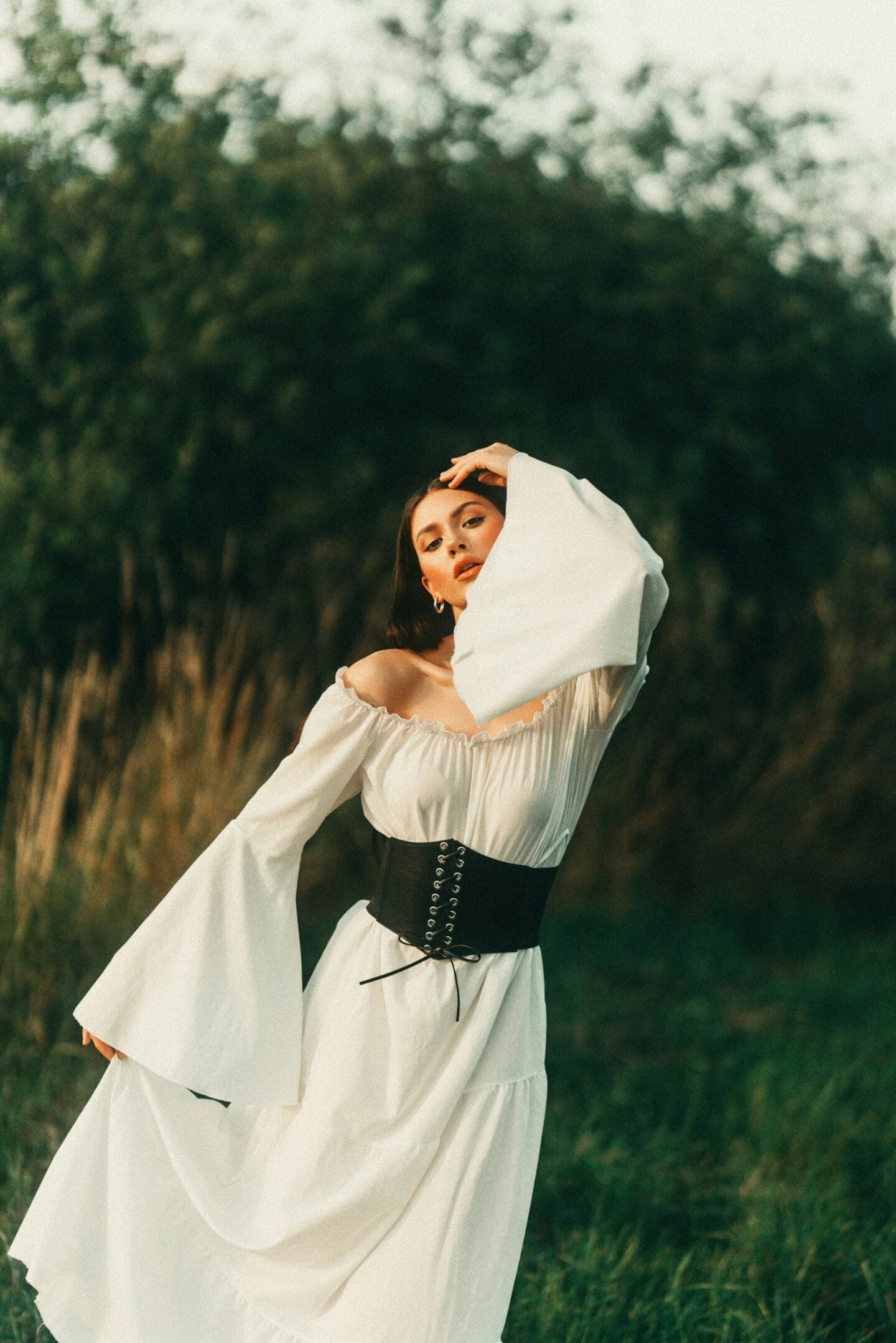 Renaissance fair outfit with flowing white gown and black corset belt