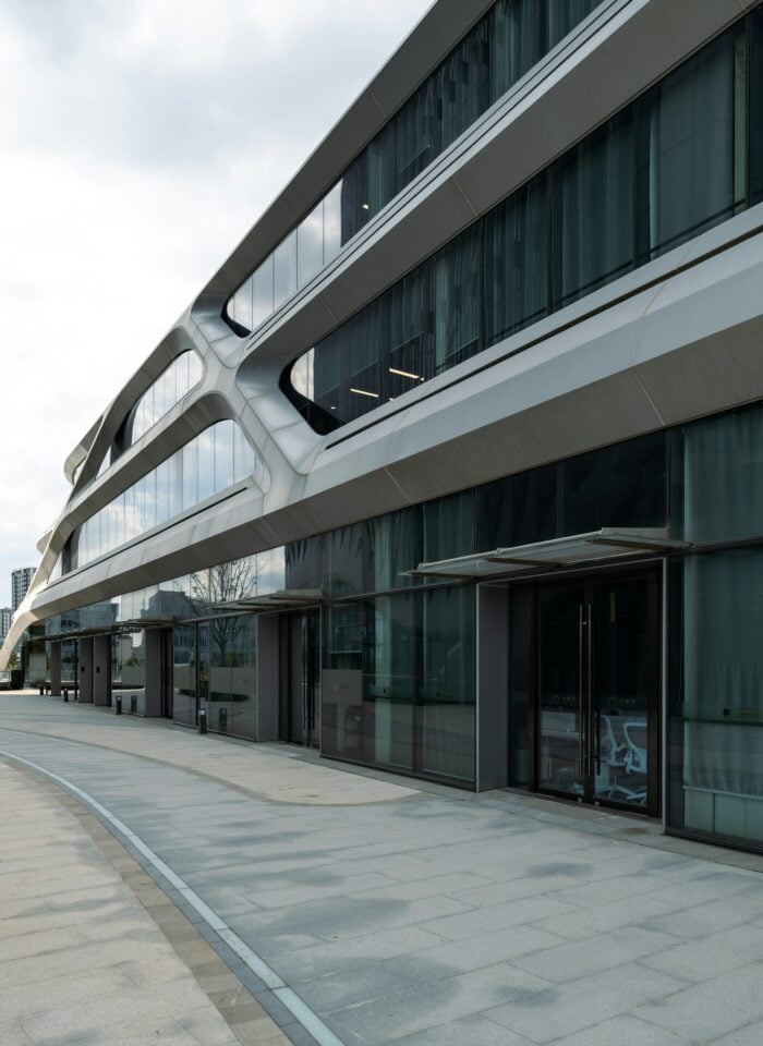 Contemporary office building with large glass windows and sleek architectural design.