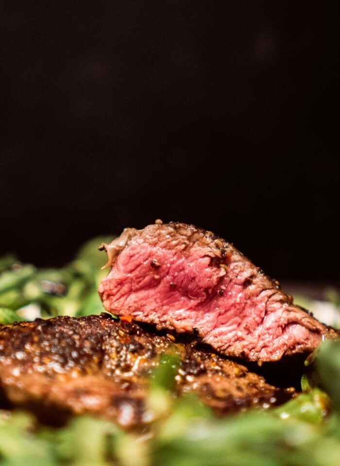 Close-up of a juicy medium-rare steak on a plate at a steak restaurant.