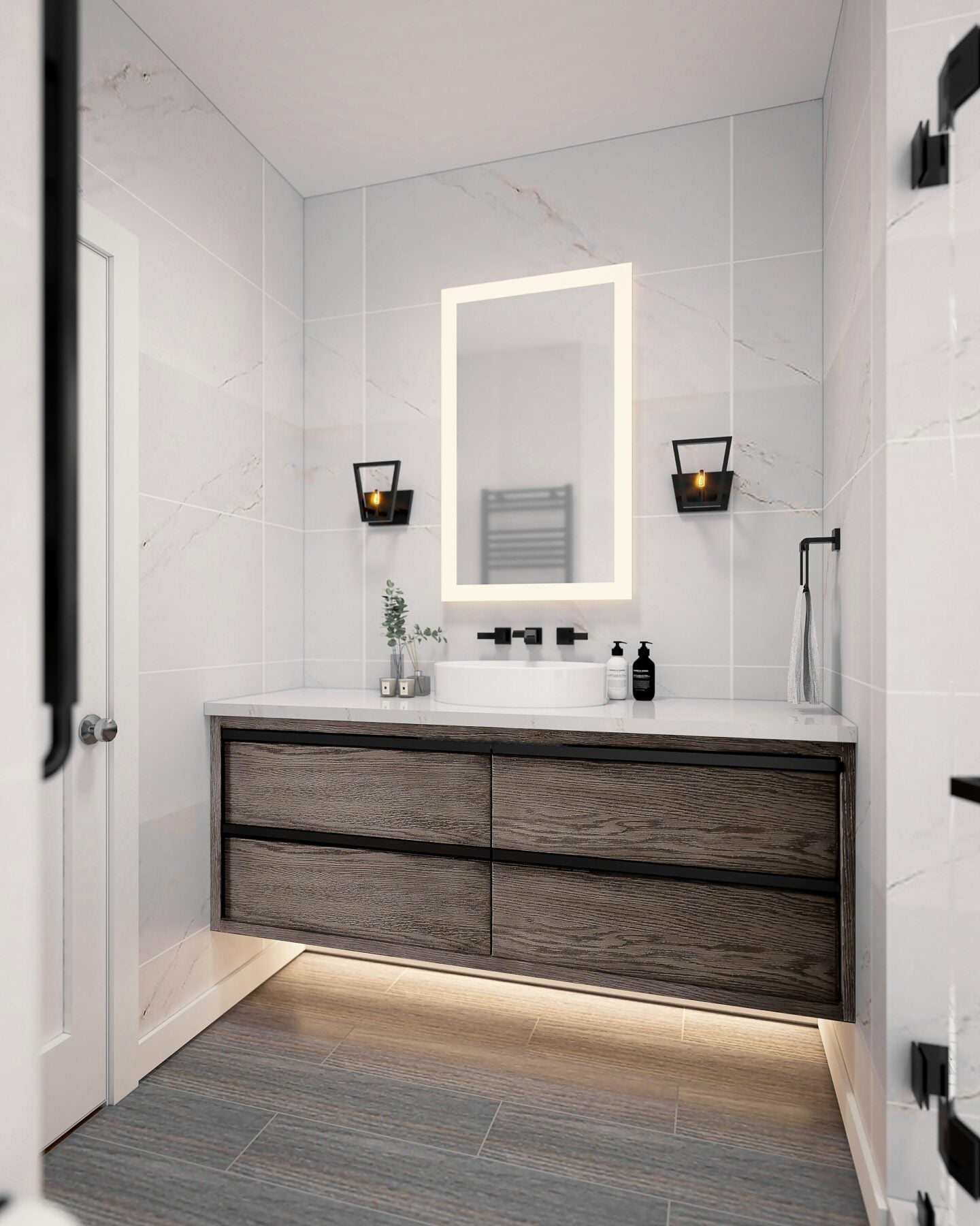 Minimalist bathroom with floating wood vanity, lighted mirror, black fixtures, and under vanity cabinet LED lighting on gray tile flooring.