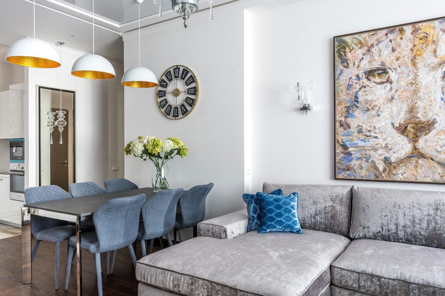 Open-plan dining and living area with modern art and plush seating, illustrating upside-down house layouts with entertaining upstairs.