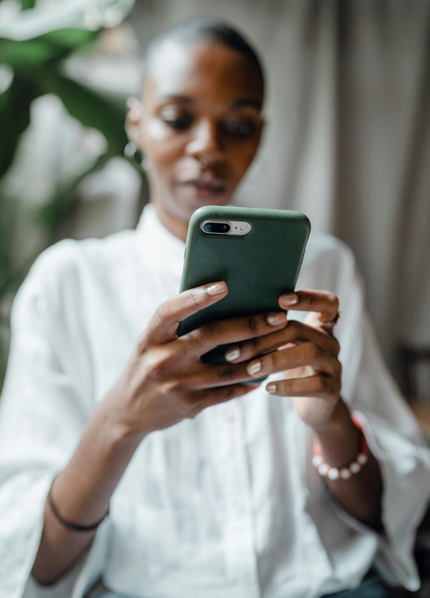 Woman checking office alarm notification on her smartphone.