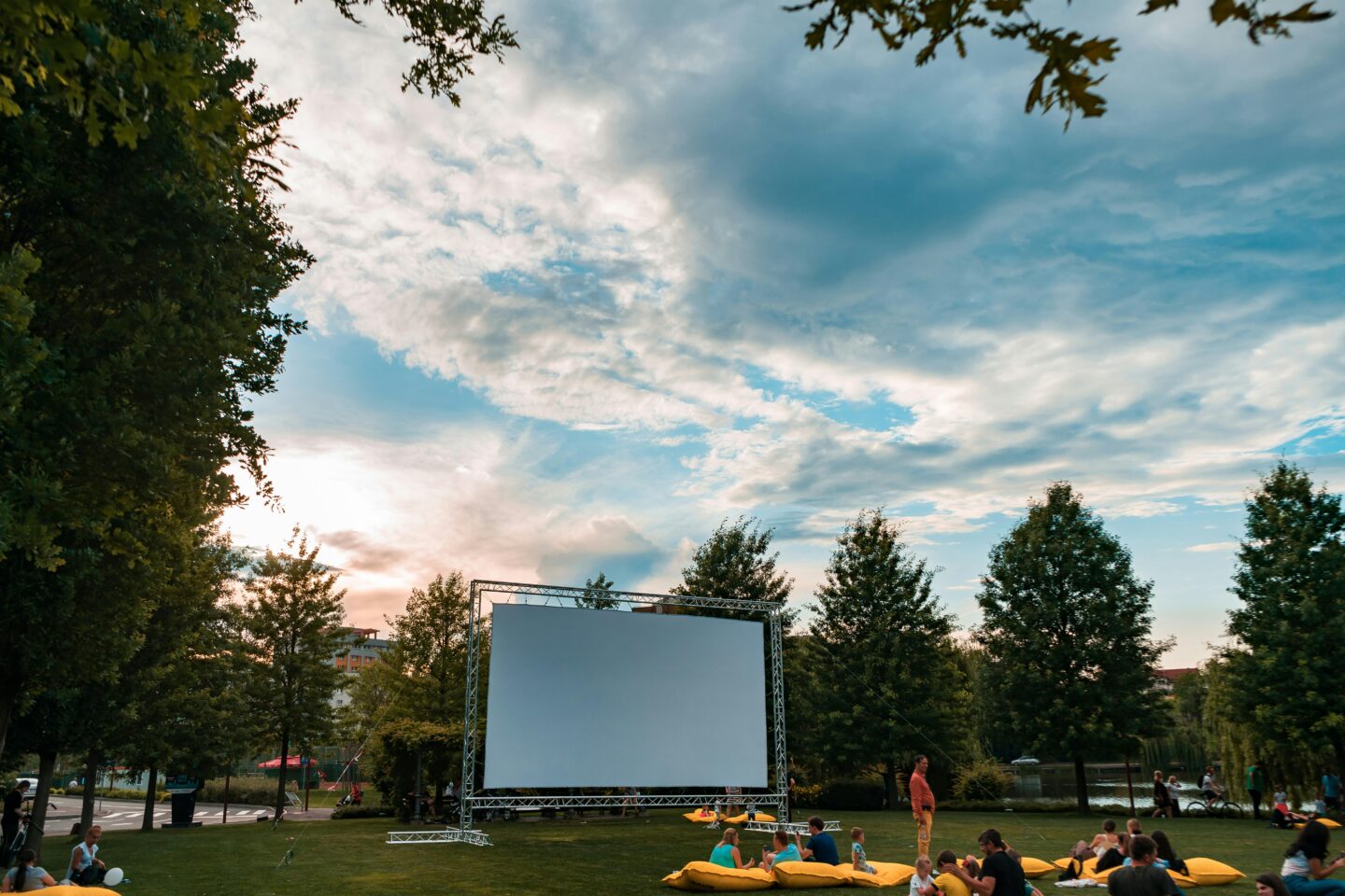 People enjoying a cozy indoor film screening on a cool autumn evening in Britain.