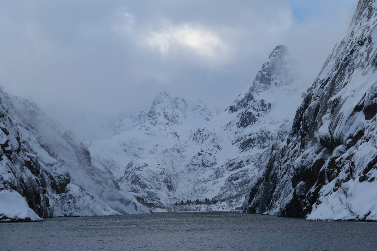 Snow-covered mountains rising from the water in Trollfjord, Lofoten Islands, Norway