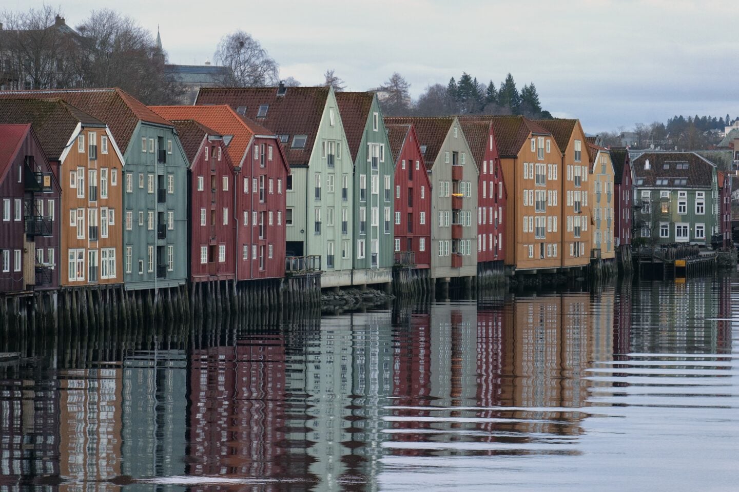 Colorful wooden houses along the river in Trondheim old town, Norway
