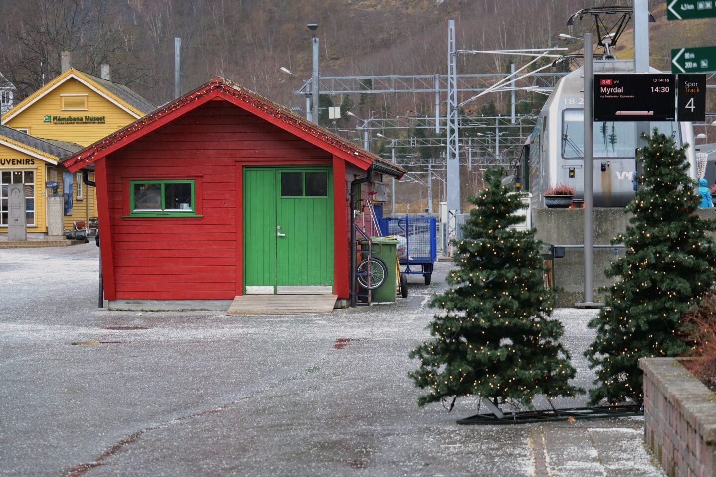 Flåm railway station area with traditional buildings and train tracks, Norway