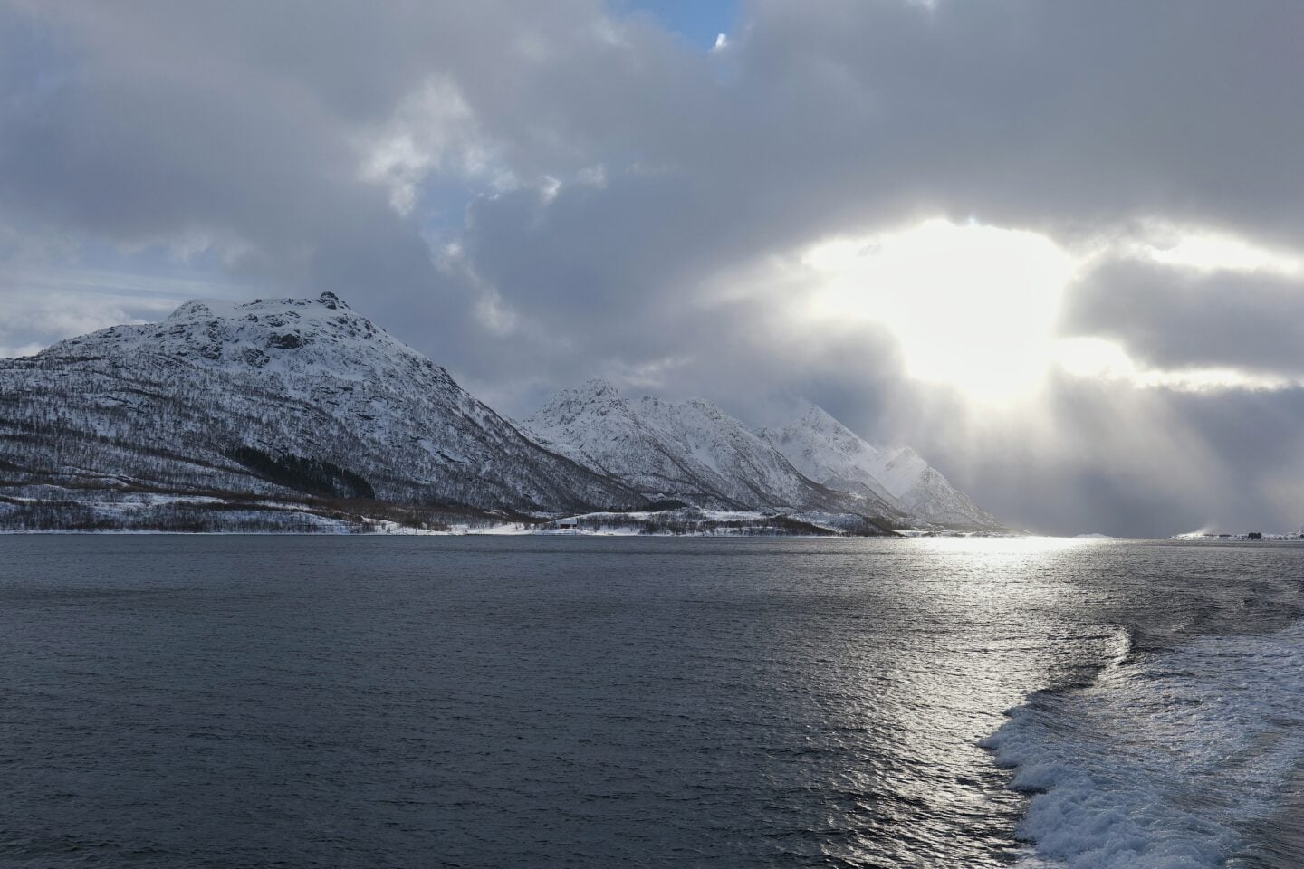 Dramatic winter scenery along the Raftsund strait with steep mountains and fjord waters, Norway