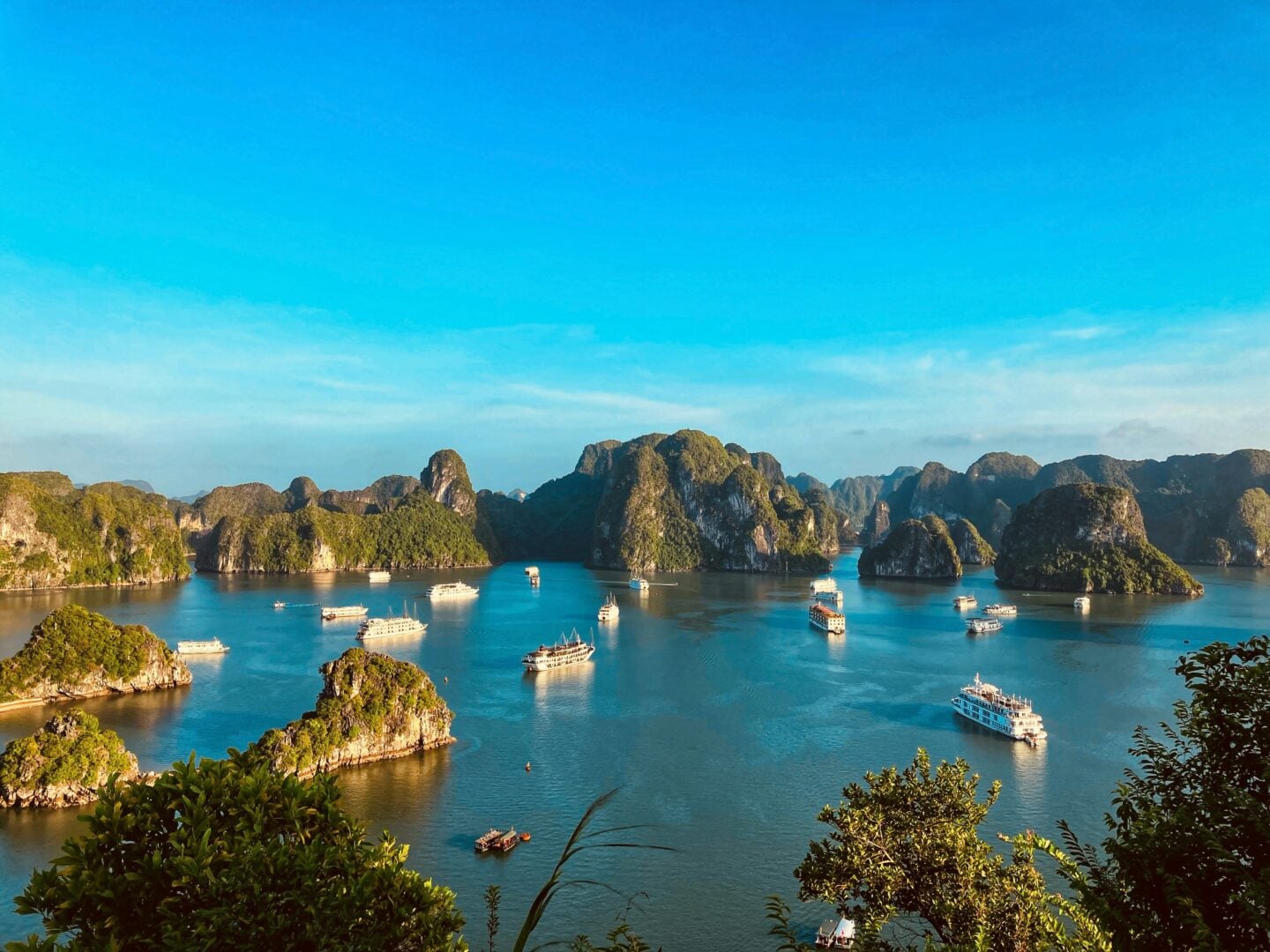 Limestone islands and cruise boats scattered across turquoise waters in Ha Long Bay, Quang Ninh Province, Vietnam.