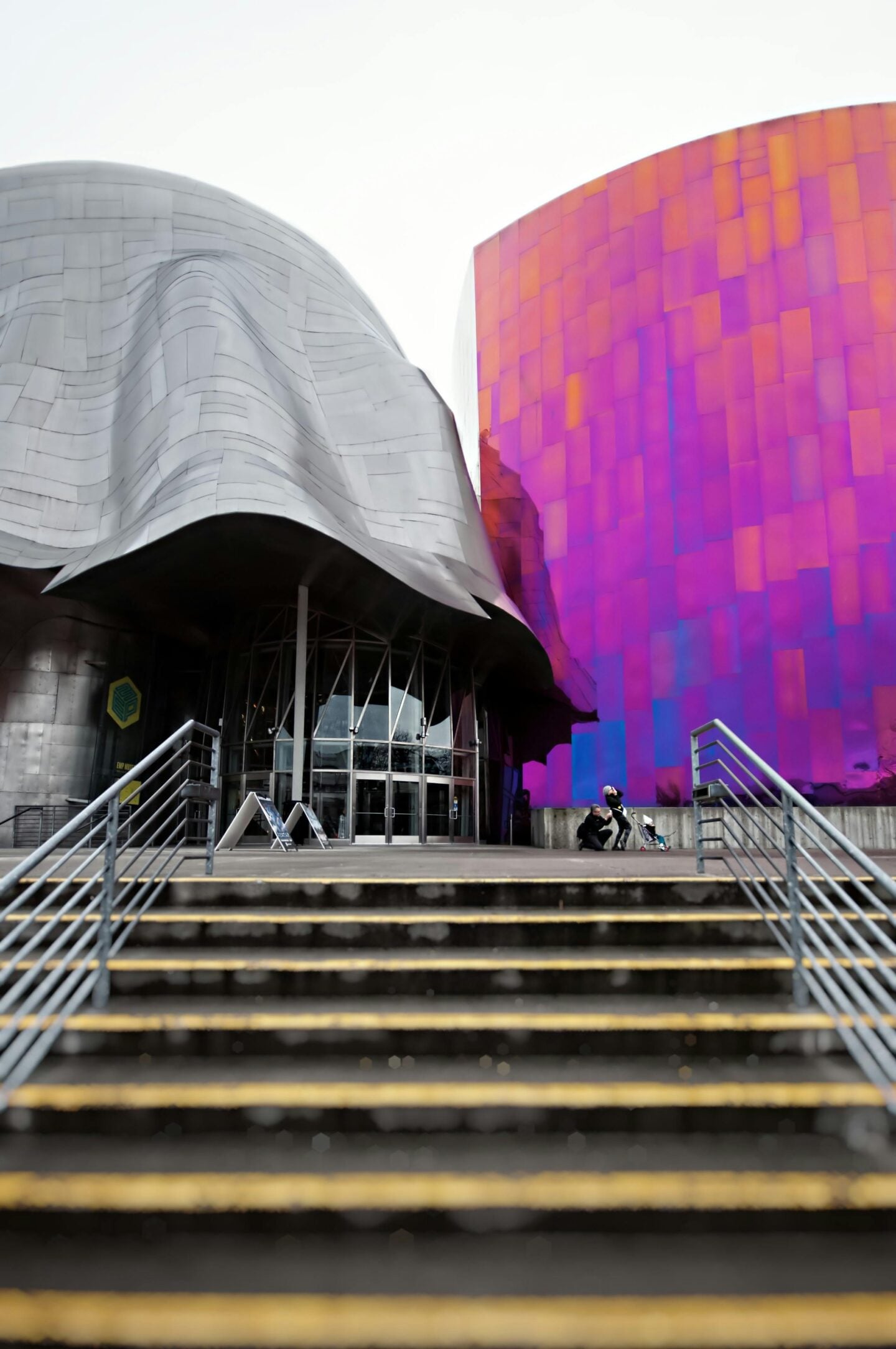 The wavy silver and vibrant purple exterior of Seattle’s Museum of Pop Culture, viewed from the staircase leading to the entrance.