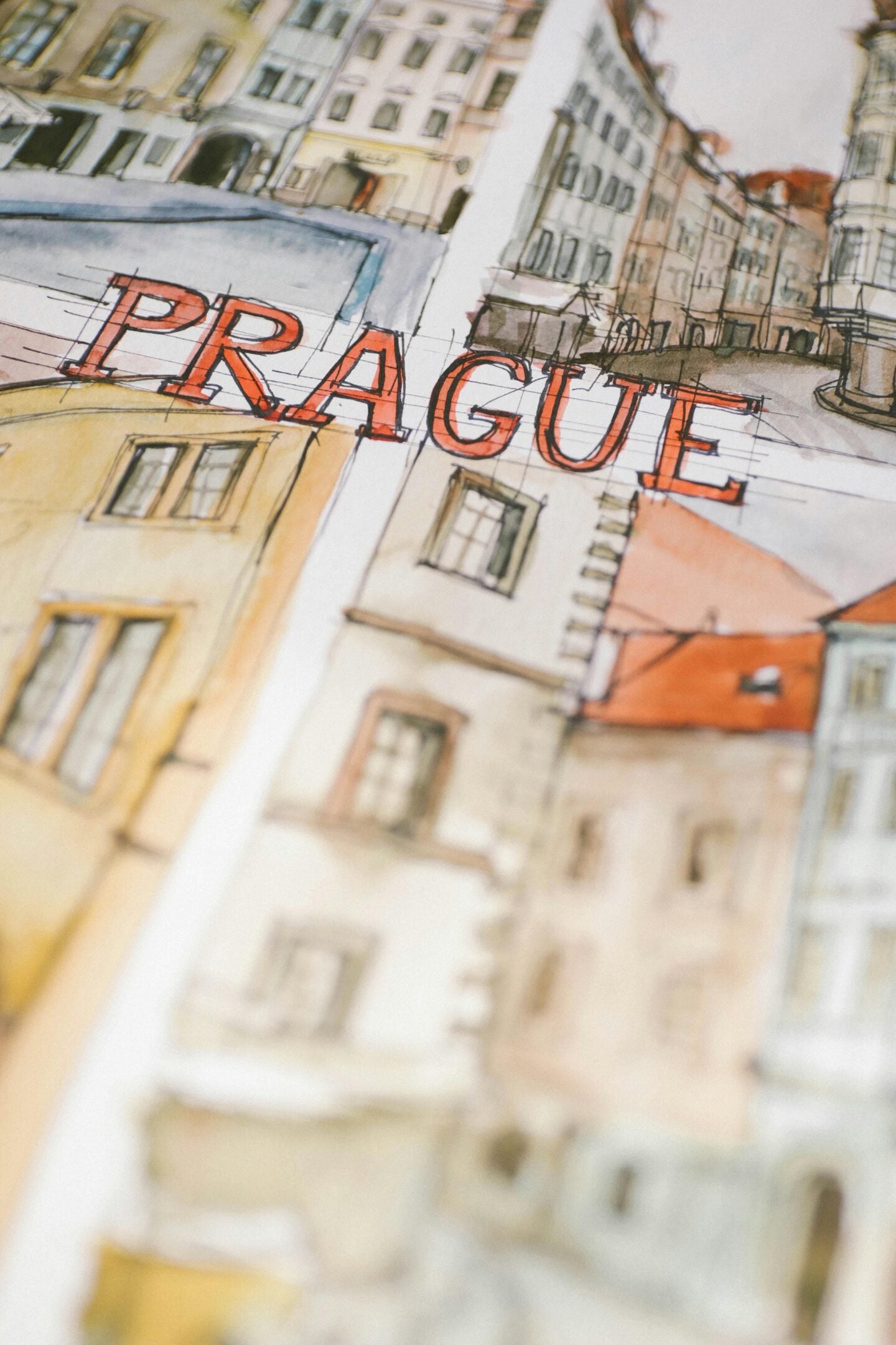 Close-up of a travel sketch featuring European buildings with the word “PRAGUE” written across the page.