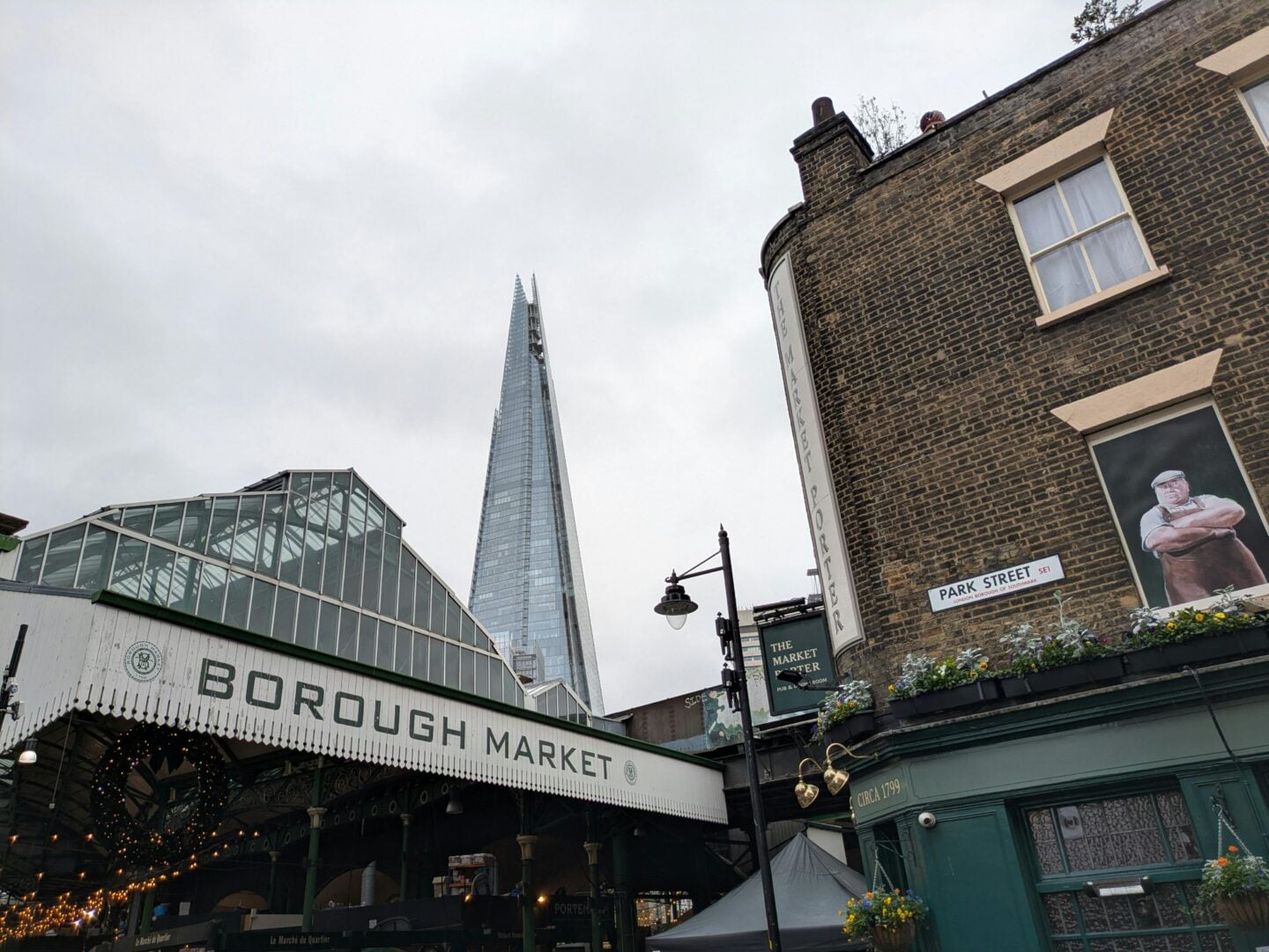 Borough Market in London with The Shard rising in the background on a winter day - one of the best places to visit in London in winter for festive food and seasonal treats.