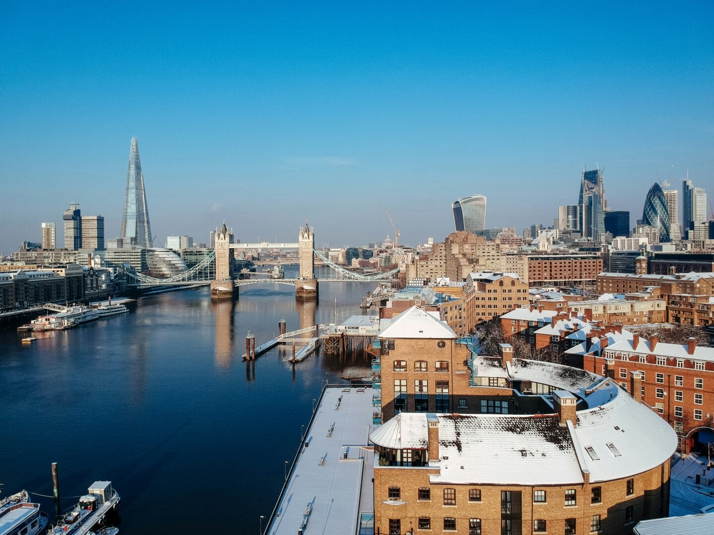 A snowy winter morning in London with Tower Bridge, The Shard, and the Thames River, showcasing one of the best winter cityscape views.