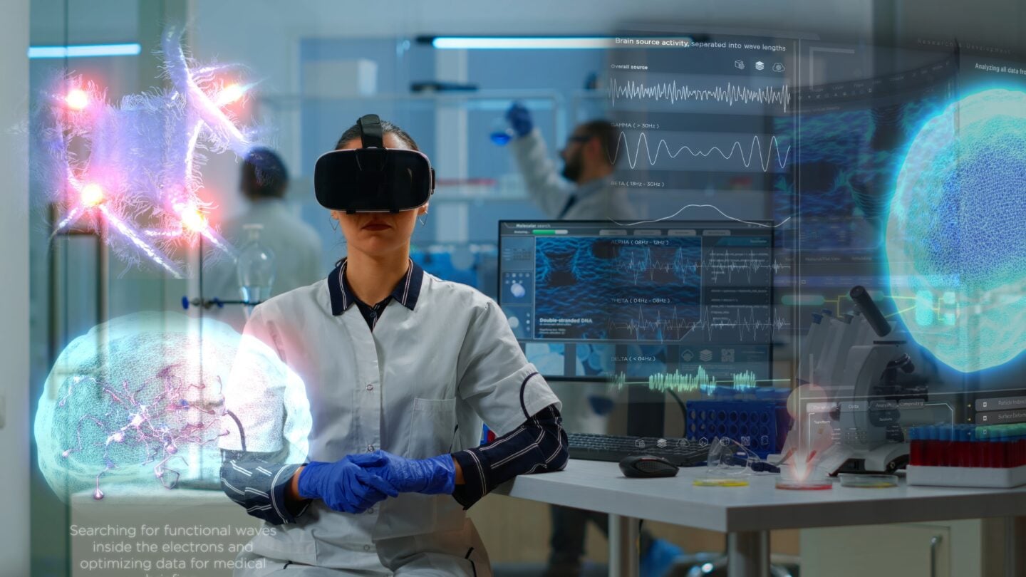 Scientist wearing a VR headset in a laboratory with holographic brain and DNA visualizations representing future healthcare technology.
