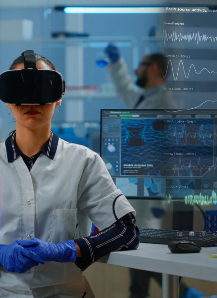 Scientist wearing a VR headset in a laboratory with holographic brain and DNA visualizations representing future healthcare technology.