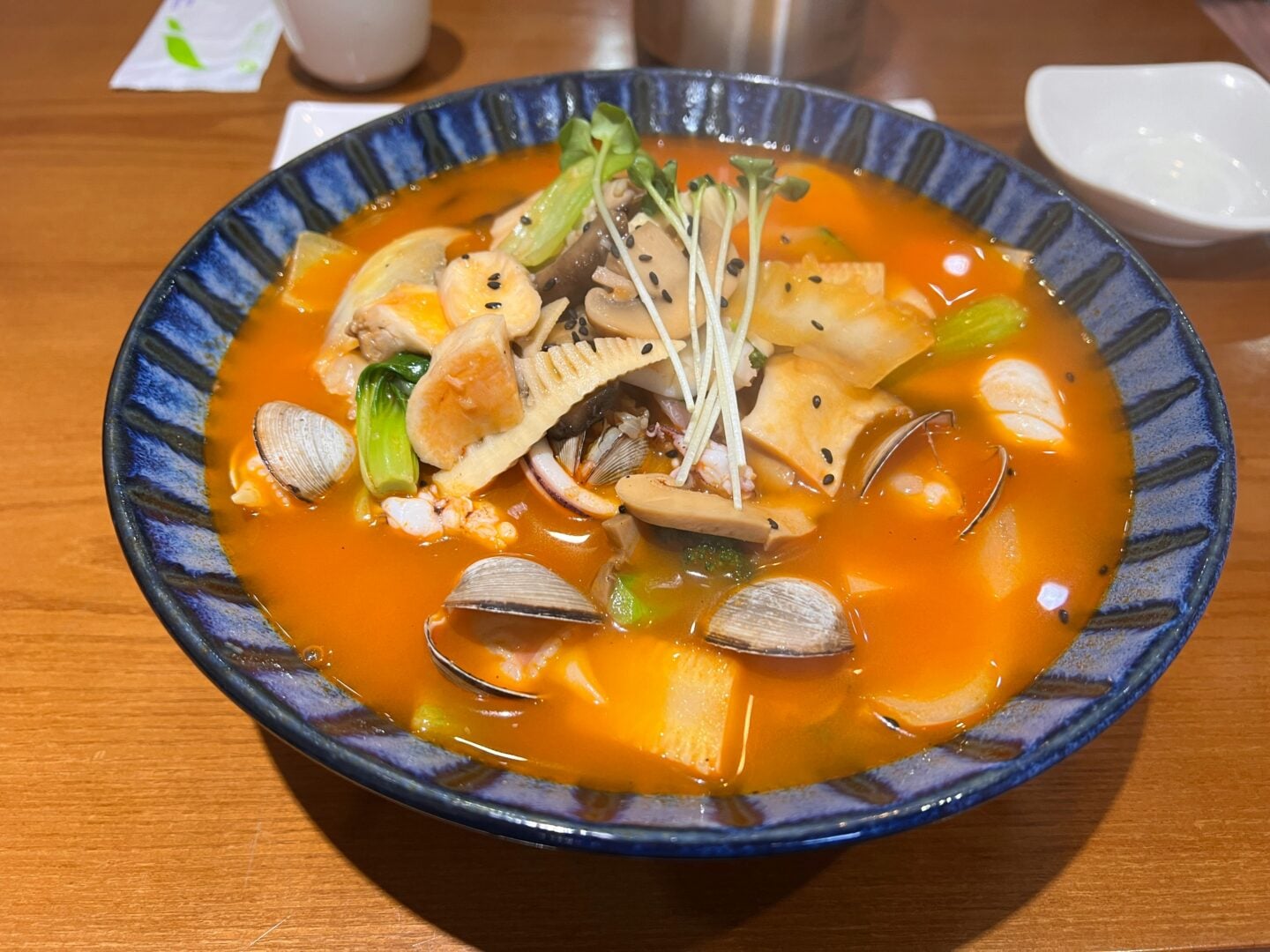 A bowl of South Korean soup with seafood.