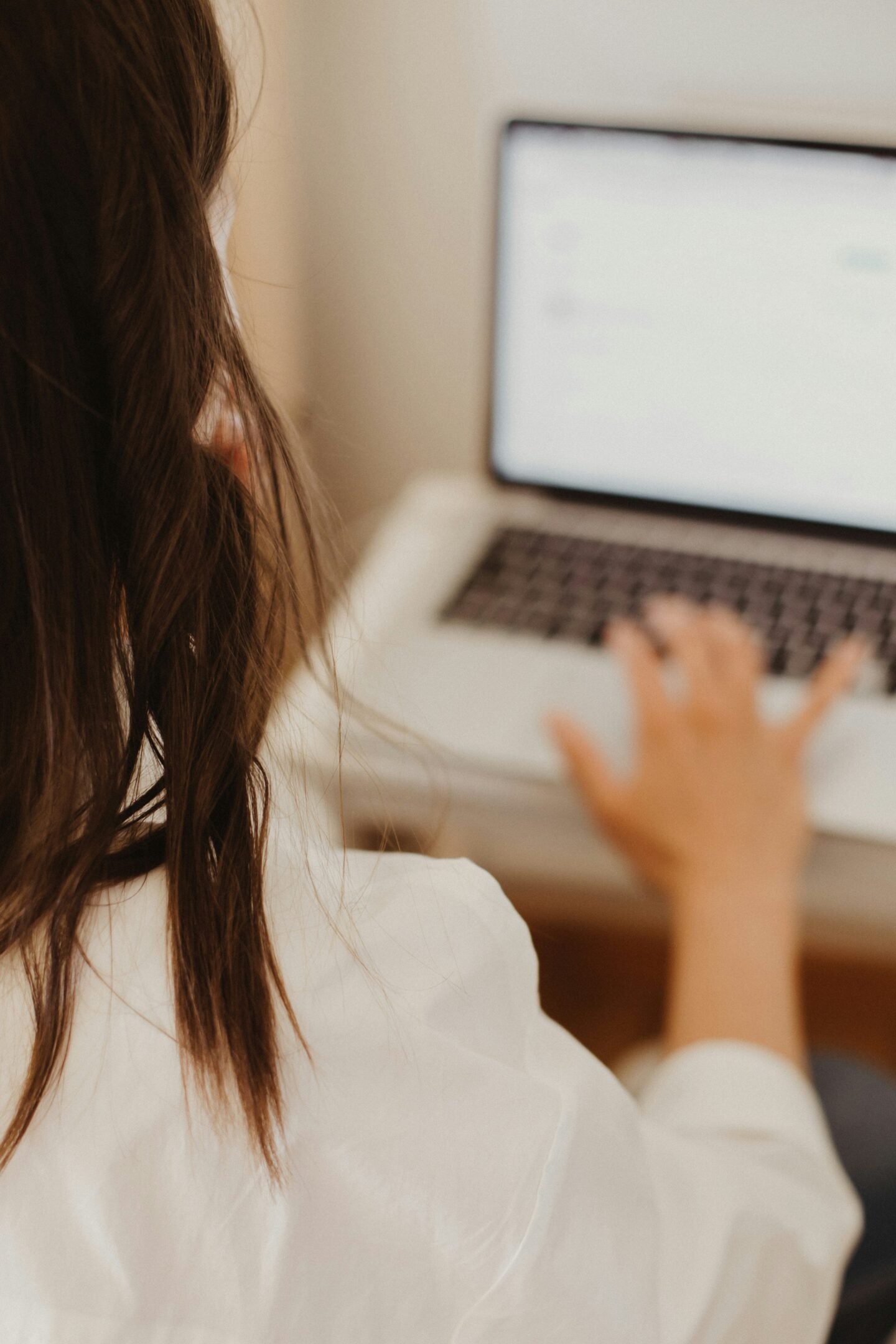 Woman searching for local home contractors online using a laptop at home.