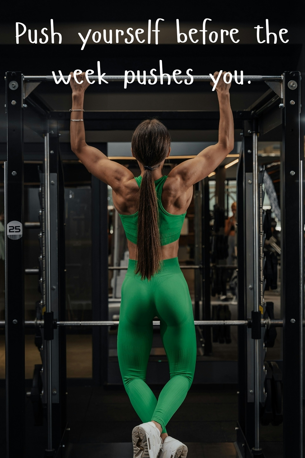 Woman in green workout clothes doing pull-ups in the gym with the quote “Push yourself before the week pushes you.”