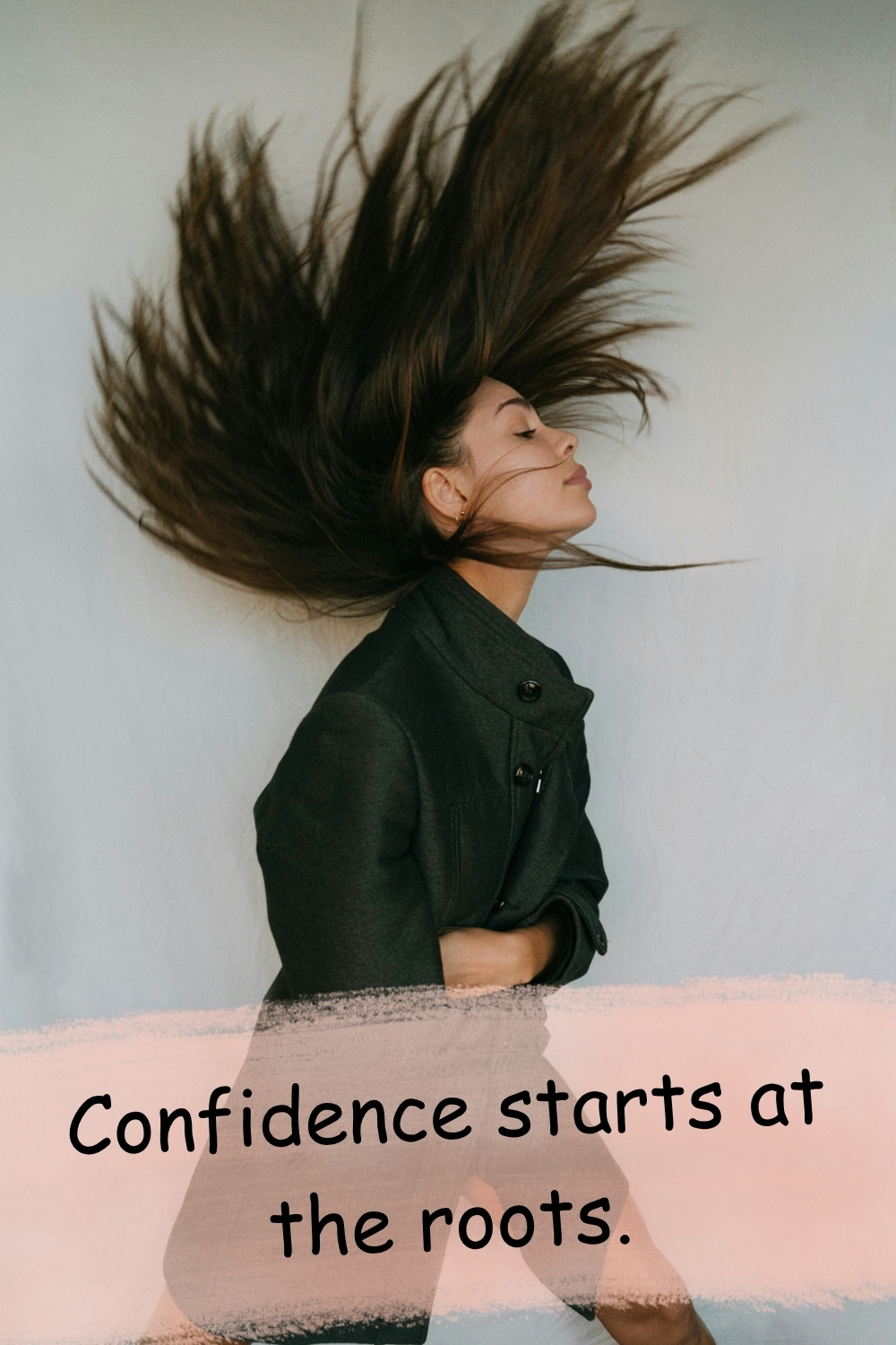 Woman flipping long dark hair dramatically against a neutral background with the quote “Confidence starts at the roots”