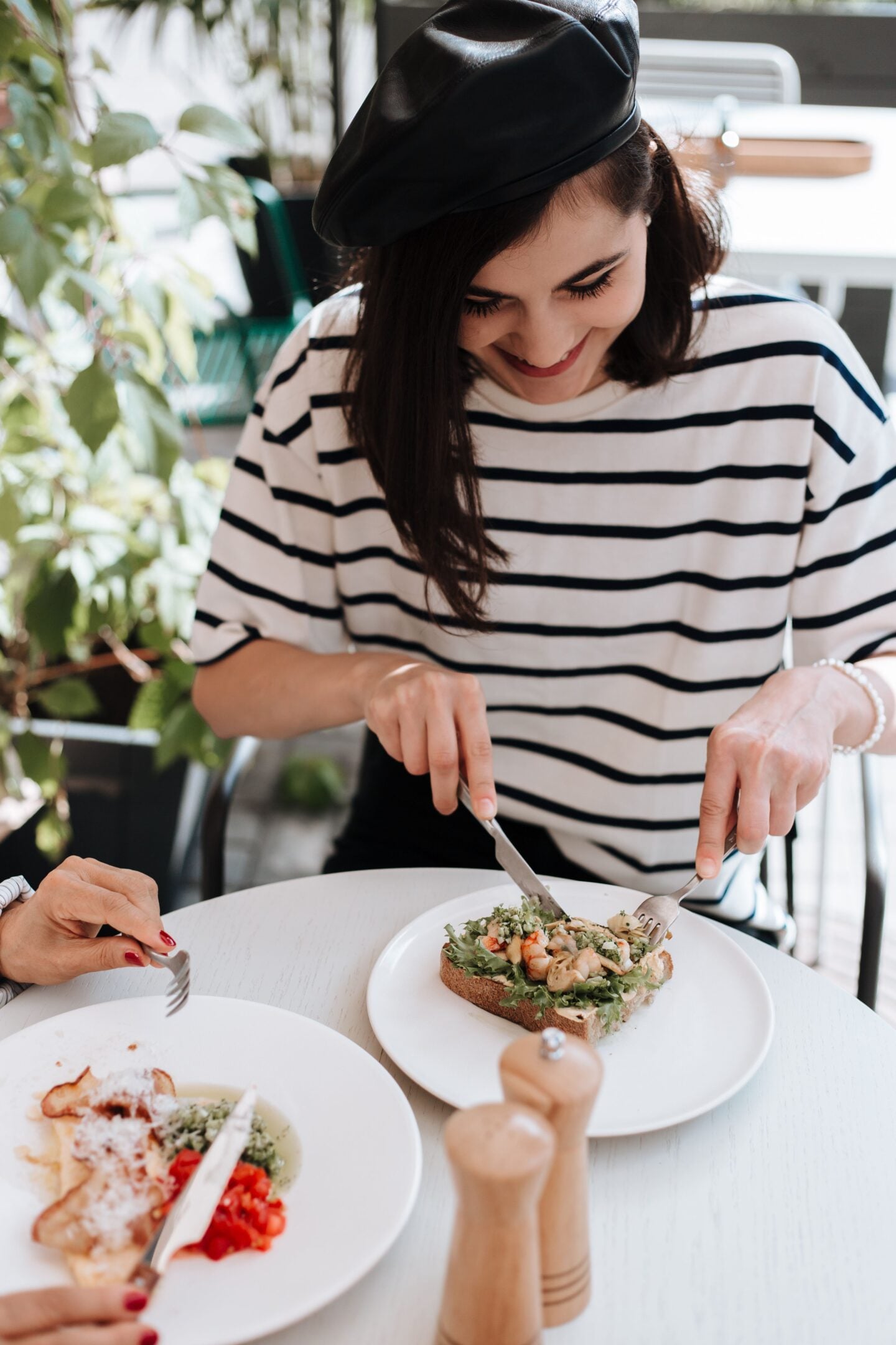Traveller enjoying fresh local food at a café while experiencing authentic cuisine during a holiday.