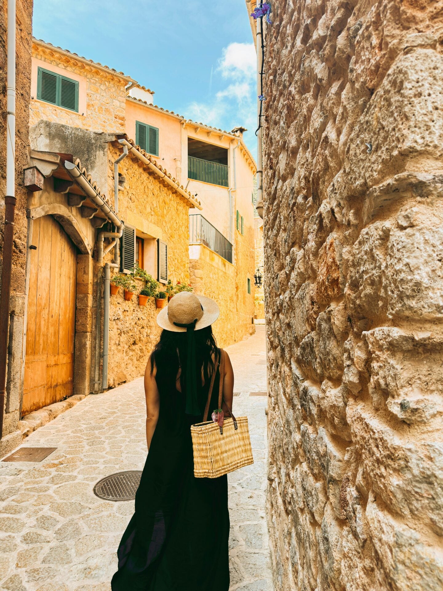 Traveller exploring a charming historic narrow street, discovering local culture beyond the main tourist attractions.