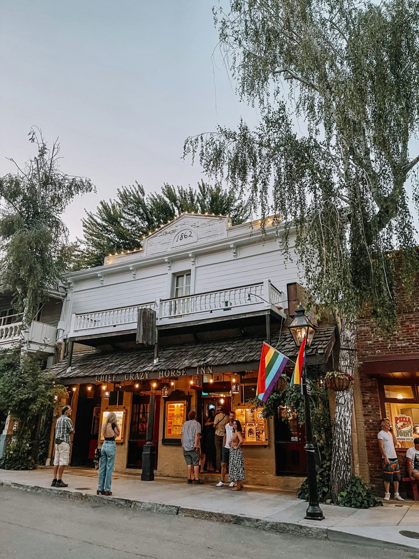 Historic streetscape with visitors outside a preserved Gold Rush-era building in Nevada City, California, USA.