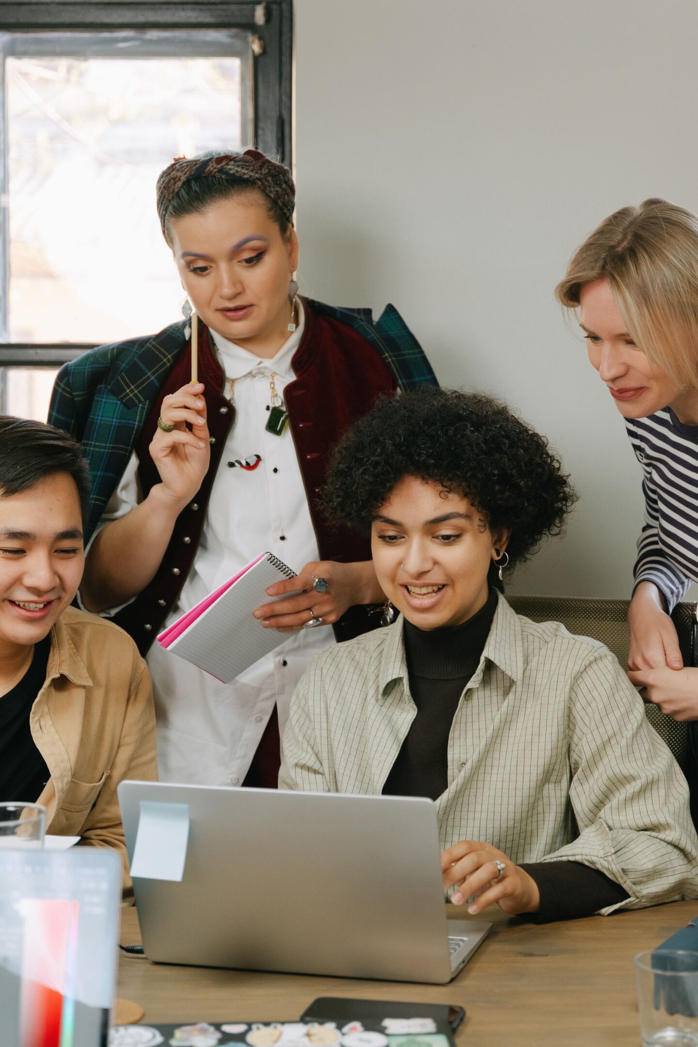 Business professionals collaborating around a laptop while planning a data-driven marketing strategy.