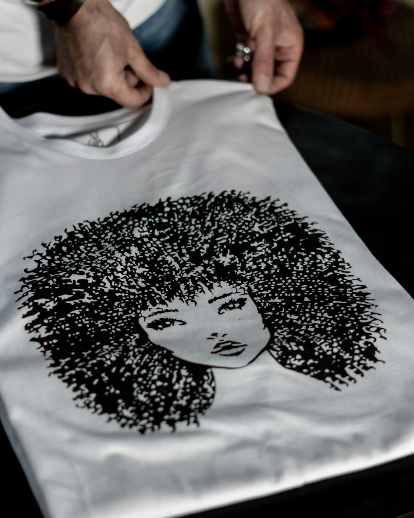 White T-shirt with a custom black graphic design.