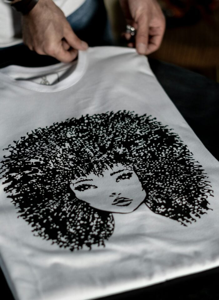 White T-shirt with a custom black graphic design.