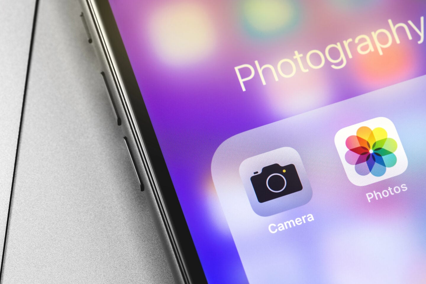 Close up of a smartphone screen showing camera and photo apps for taking and organising digital photographs.
