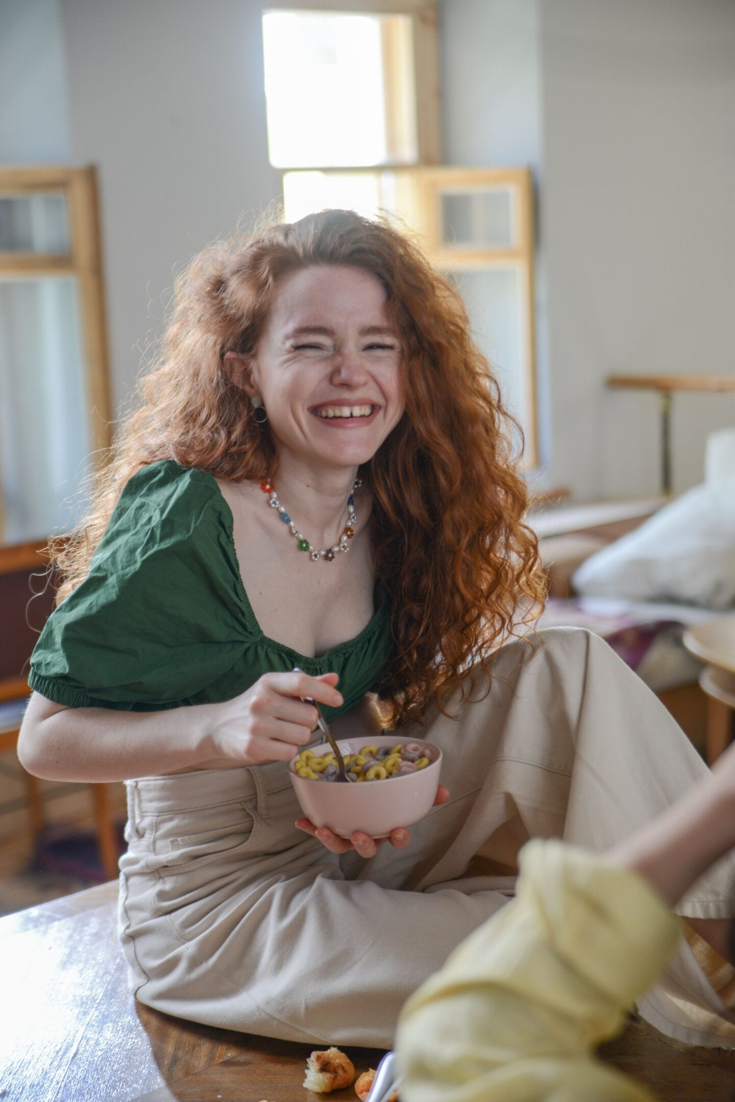 Smiling woman enjoying an everyday moment at home, an example of a candid photo worth keeping.