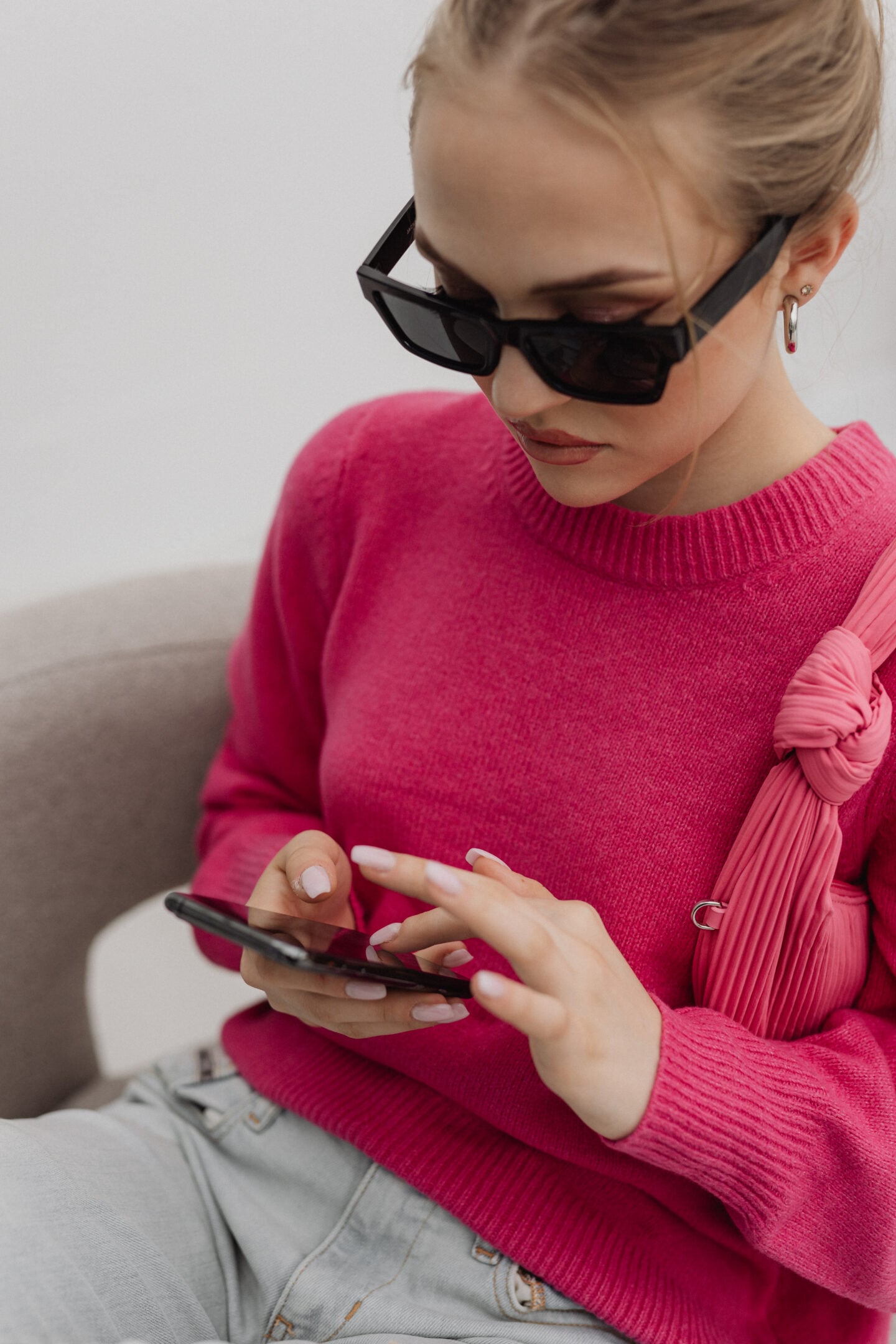 Woman looking through photos on her smartphone to choose and organise her favourite images.